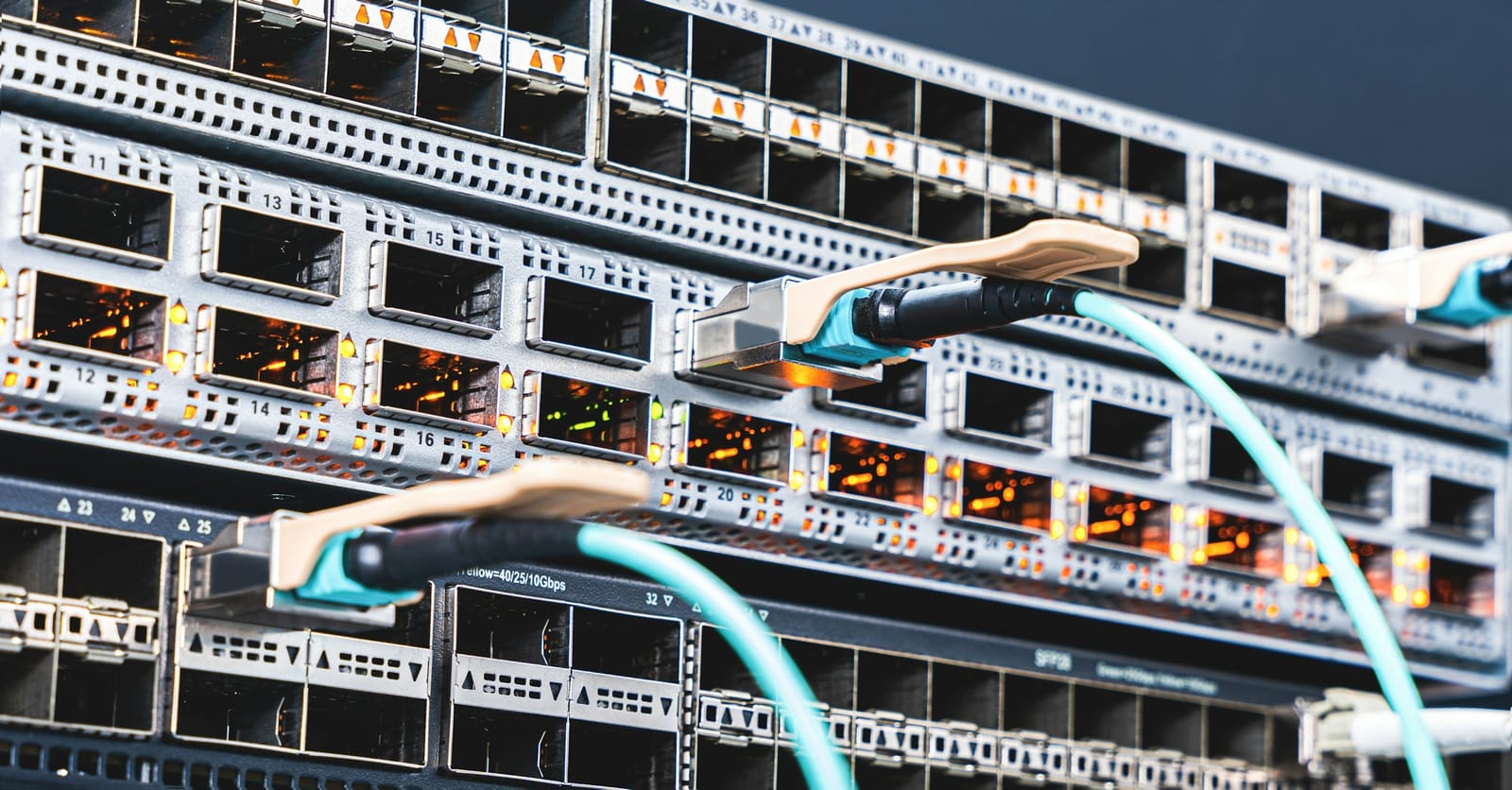 Fiber and copper patch cables connected to a rack-mounted network switch