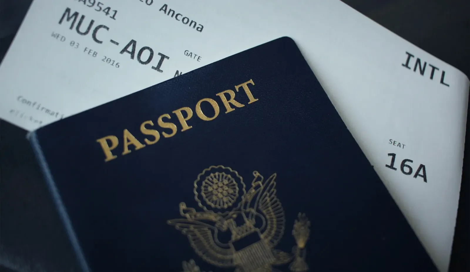 A U.S. passport resting on an international boarding pass.