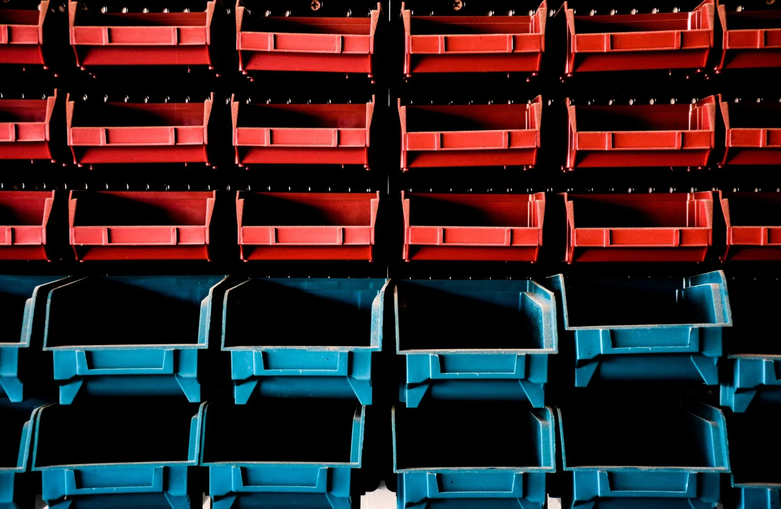Rows of red and blue storage bins.